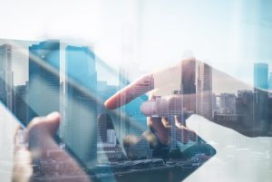 41925620 - double exposure of city and hands using tablet